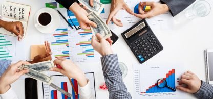 Picture of businessmen's hands on white table with documents, coffee and drafts